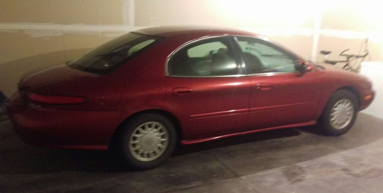1997 Mercury Sable GS | Sioux Falls, SD, Toreador Red Clearcoat Metallic (Red & Orange), Front Wheel