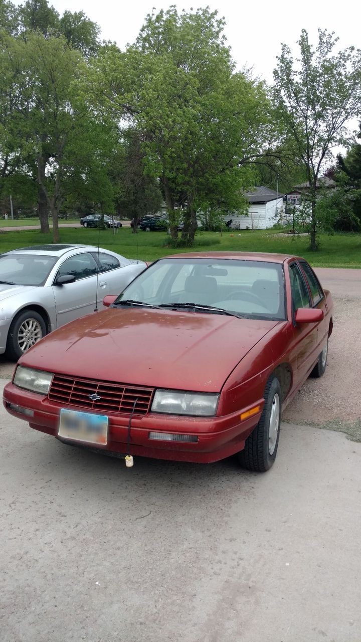 1996 Chevrolet Corsica Base | Mitchell, SD, Medium Garnet Red Metallic (Red & Orange), Front Wheel