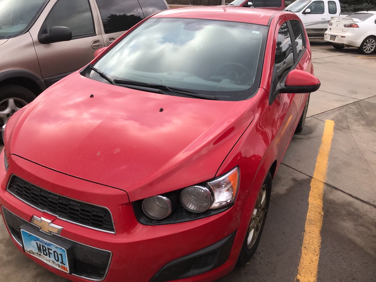 2012 Chevrolet Sonic LS | Sioux Falls, SD, Victory Red (Red & Orange), Front Wheel