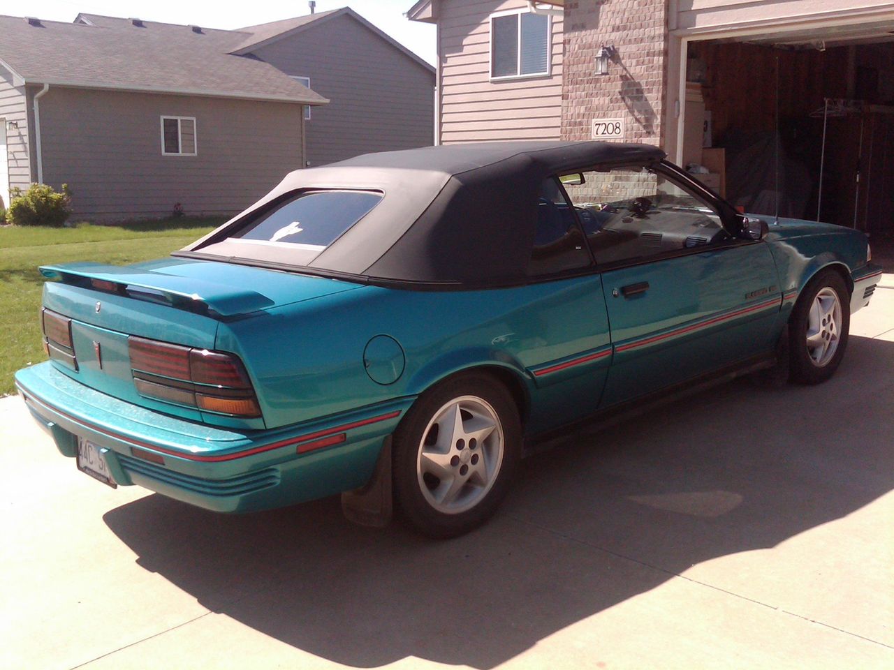 1993 Pontiac Sunbird SE | Sioux Falls, SD, Bright Aqua Metallic (Blue), Front Wheel