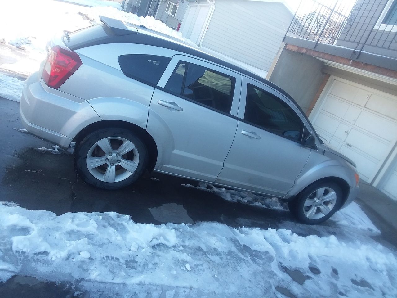 2010 Dodge Caliber SXT | Sioux Falls, SD, Light Sandstone Metallic Clear Coat (Gray), Front Wheel