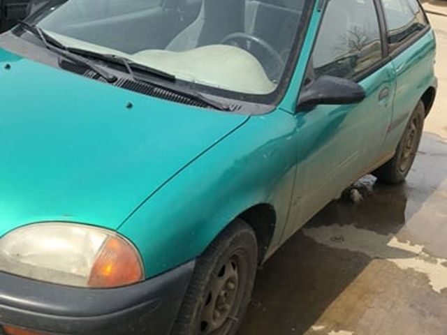 1994 Geo Metro Base, Tropical Green Metallic (Green), Front Wheel